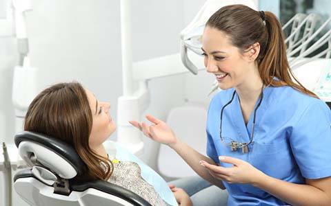 patient talking with her implant dentist