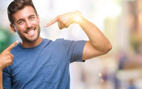 man pointing to his smile after teeth whitening in Corte Madera