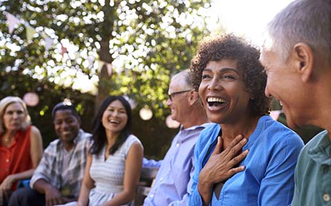 group of people laughing together outside